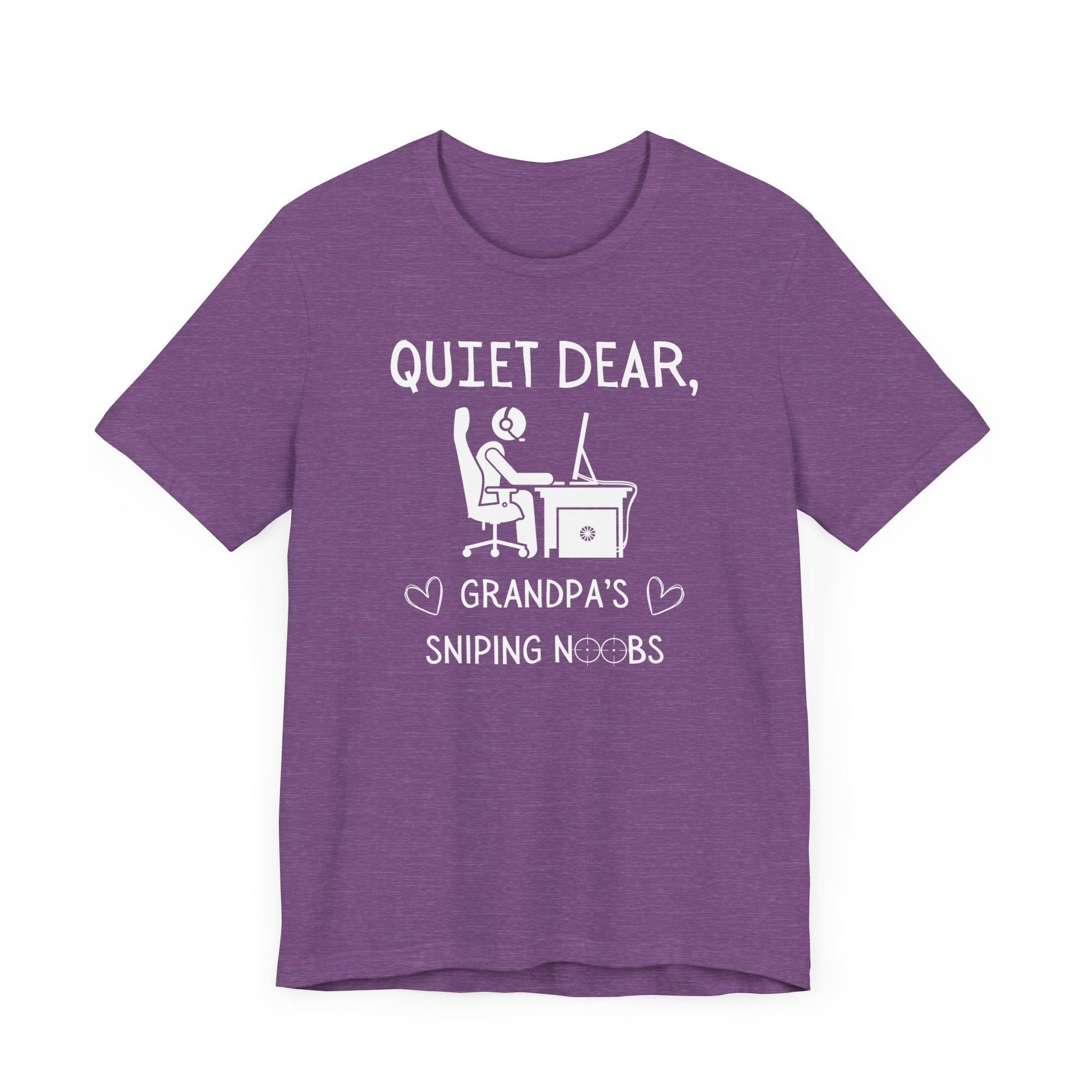 A flat image of a purple heather t-shirt that reads Quiet Dear, Grandpa's Sniping Noobs in white text. The lower text is framed by two hearts, and the O's are in the shape of sniper scopes. In the center of the shirt is an image of a person at a desk with a gaming PC.