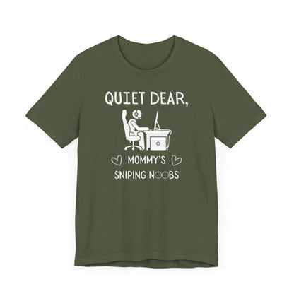 A flat image of a military green t-shirt that reads Quiet Dear, Mommy's Sniping Noobs in white text. The lower text is framed by two hearts, and the O's are in the shape of sniper scopes. In the center of the shirt is an image of a person at a desk with a gaming PC.